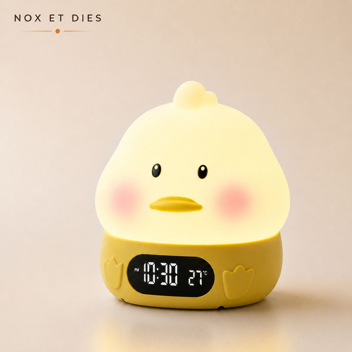 Veilleuse réveil Canneton Nox et Dies en silicone jaune, écran affichant l'heure et la température