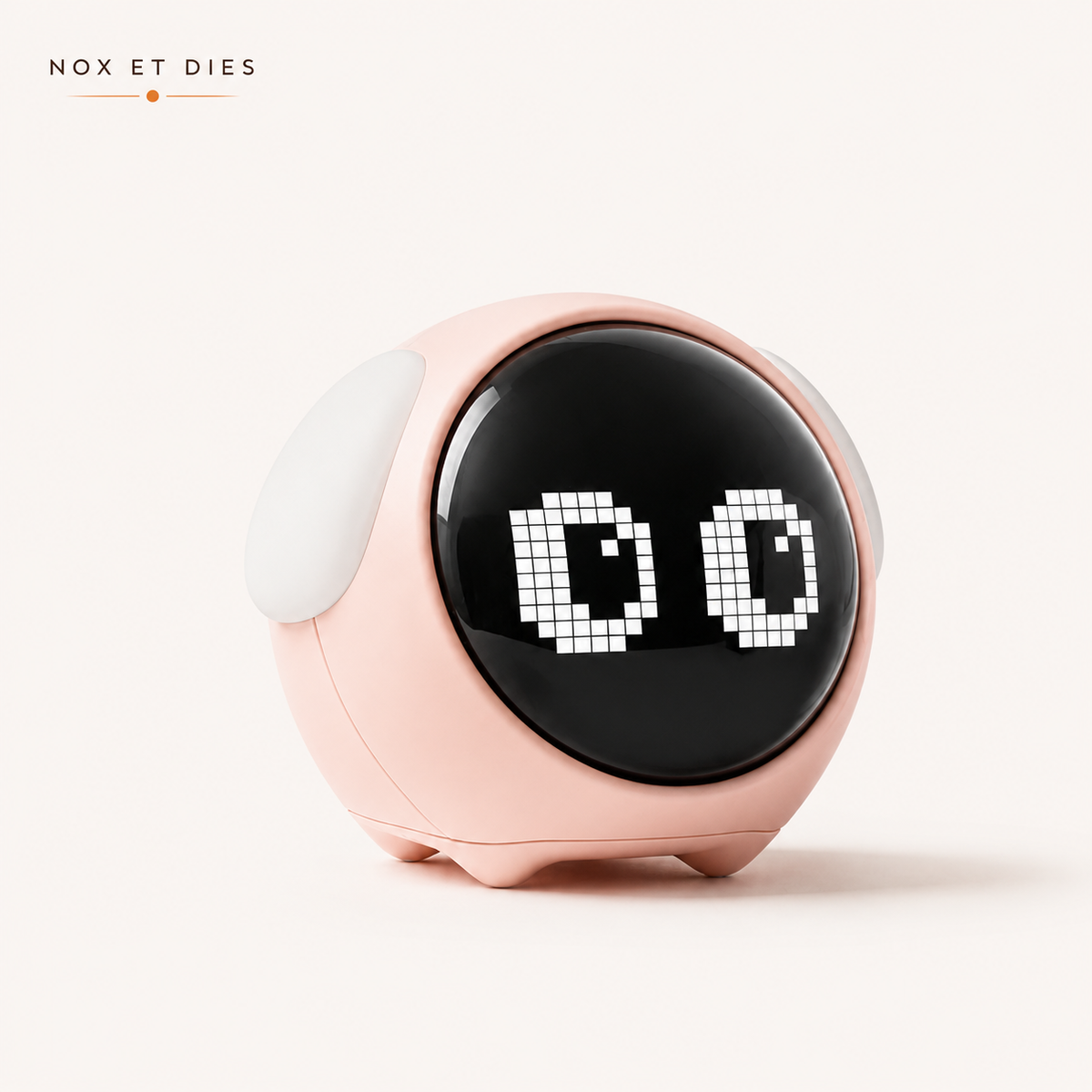 Réveil veilleuse Mimi Nox et Dies coloris rose, écran rond affichant une expression d'yeux animée façon pixel art